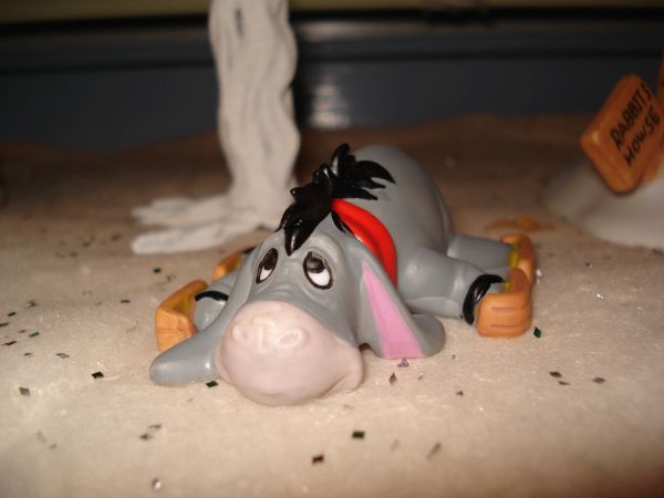 Eeyore wiped out on skates ceramic figurine