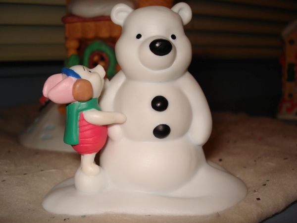 Piglet building a Pooh snowman